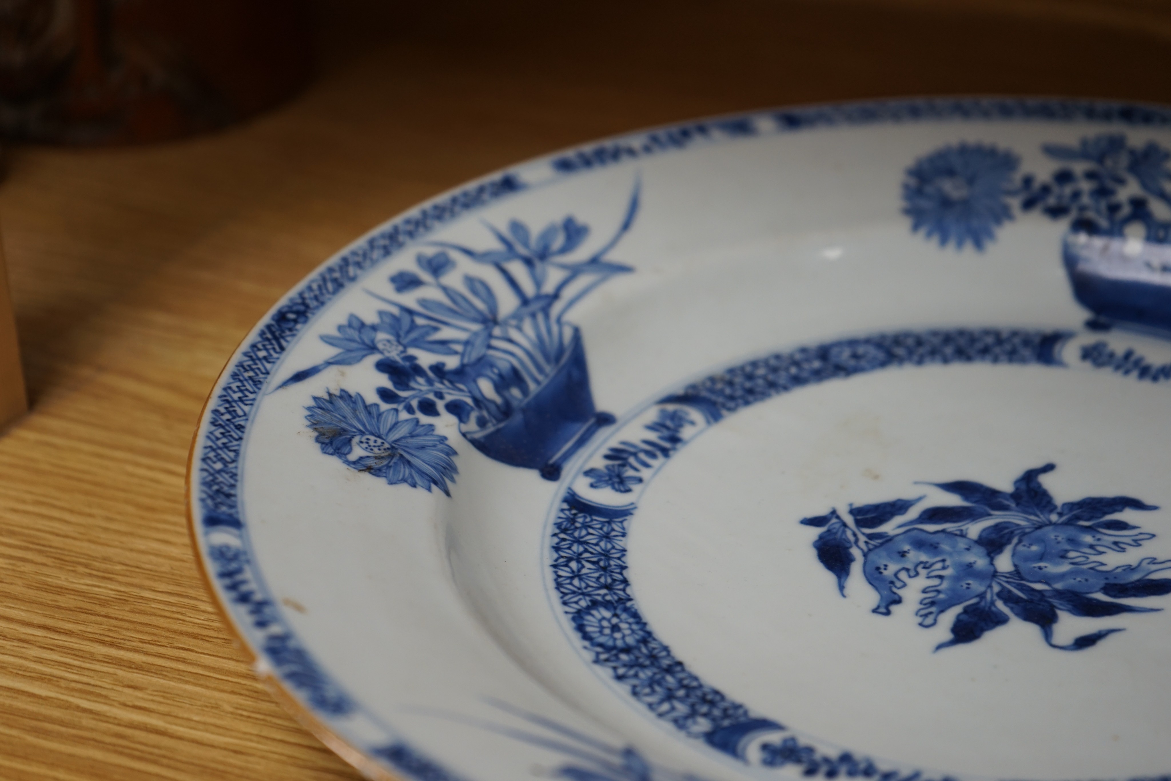 An 18th century Chinese blue and white circular dish decorated with flowering plants, Dia 32.5cm